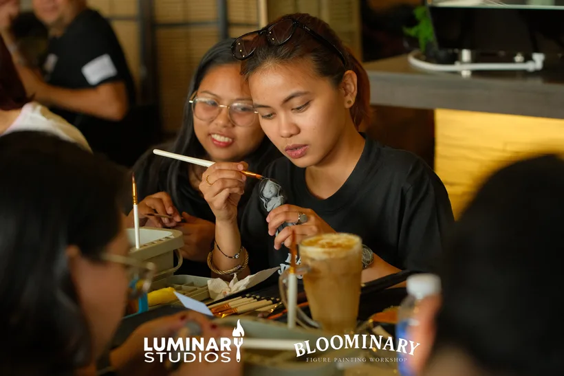 Painters working together on custom BINI 3D figures at Brew & Co. Calamba